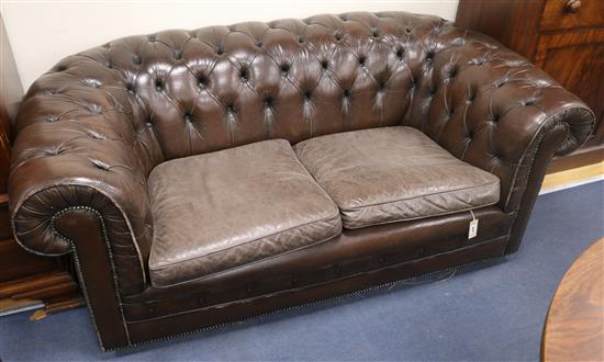 A buttoned brown leather Chesterfield settee, 182cm